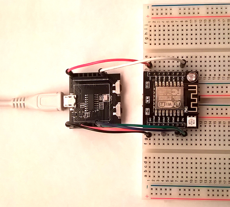 Witty Cloud top PCB on breadboard, connected to bottom PCB with 6 jumper wires for flashing