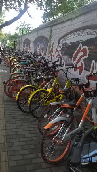 a row of shared bikes outside a subway station in Nanjing