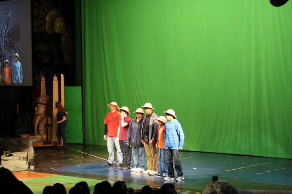 six audience members standing in front of a green curtain, 2011-12-24