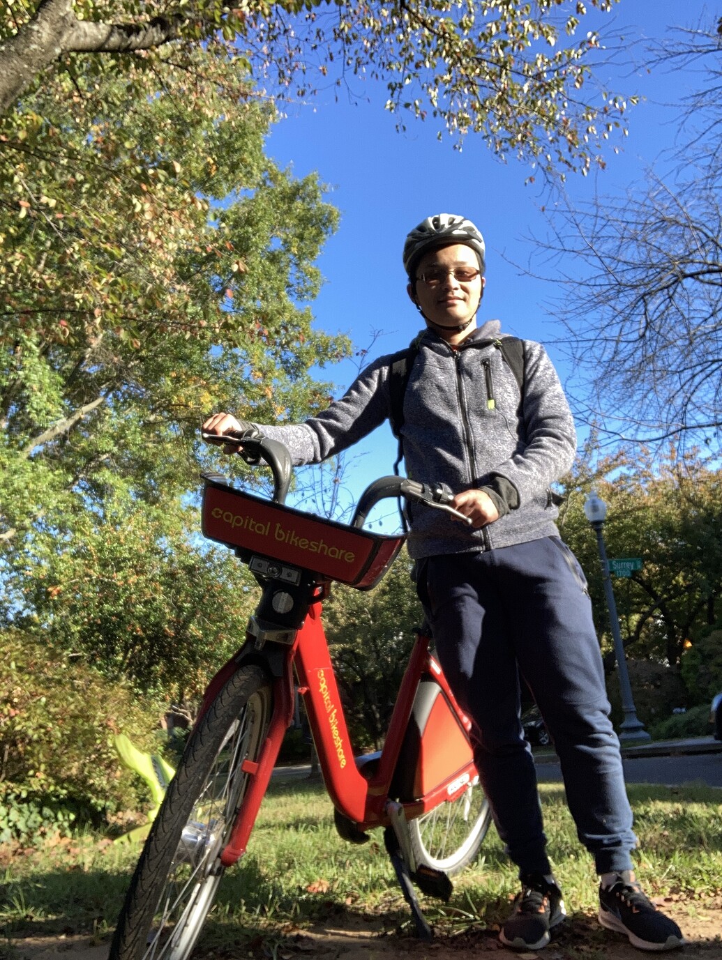 standing with Capital Bikeshare bicycle